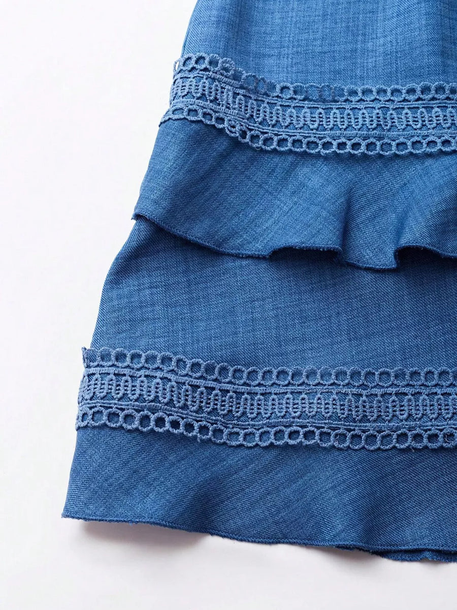 Blue denim mini dress with tiered ruffles and lace trim detail
