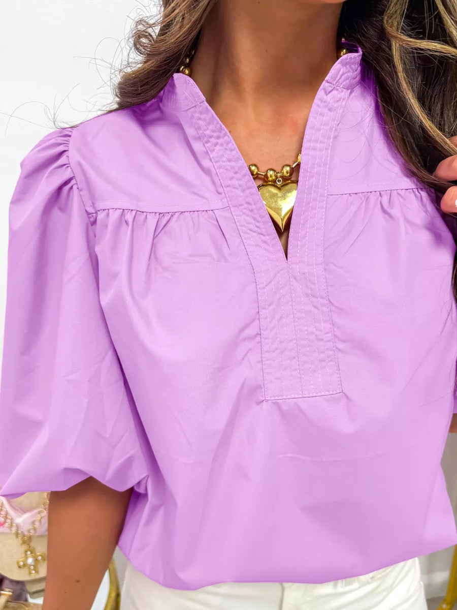 Lavender cotton shirt with notched V-neck, pintuck detail, and puff sleeves.