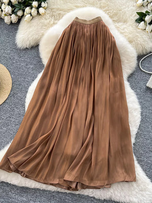 Brown pleated maxi skirt with a flowy, elegant cut.