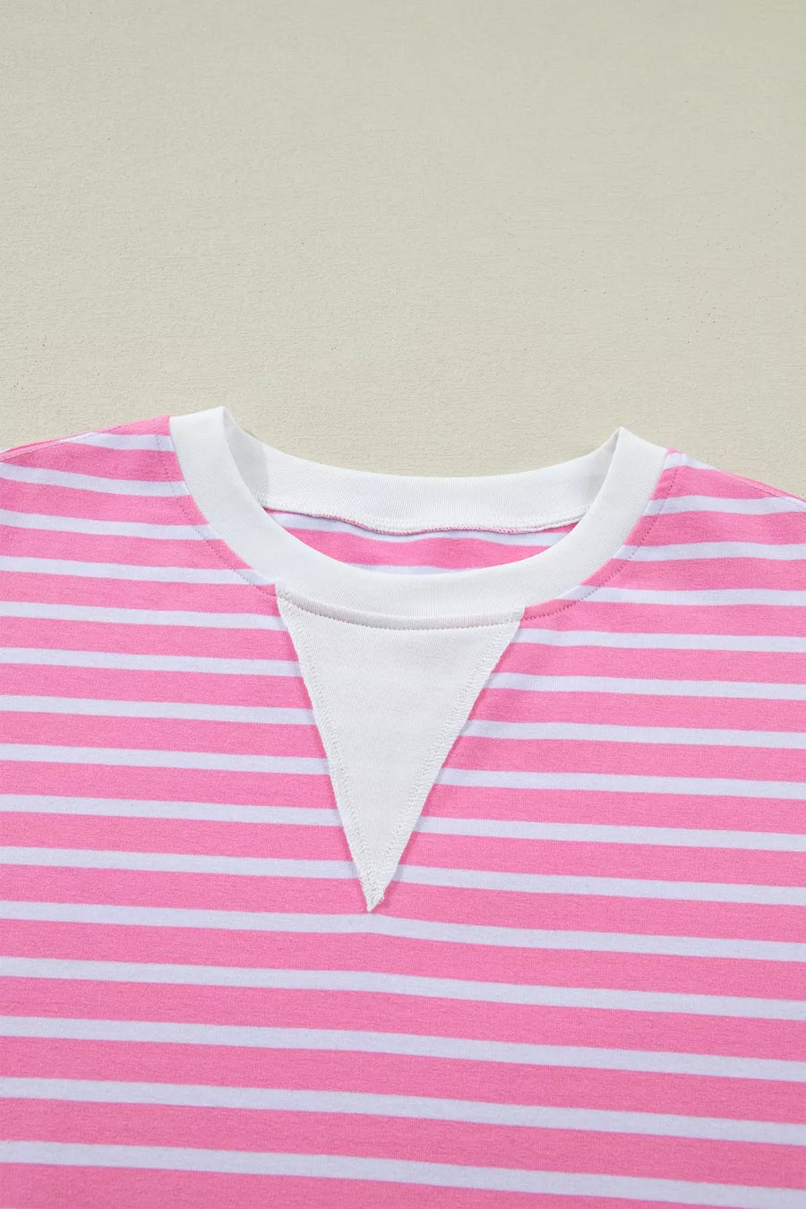 Pink and white striped cotton t-shirt with round neck and white inset detail.