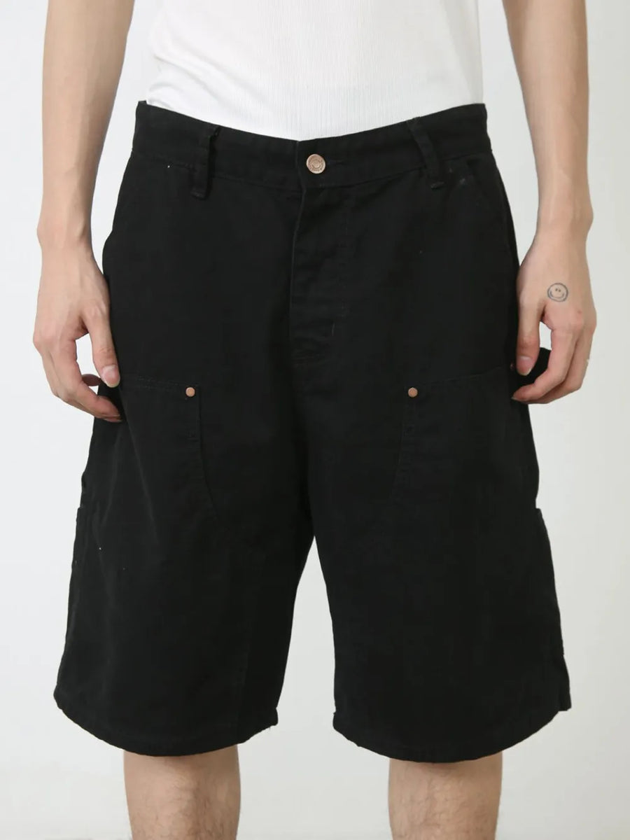 Black denim carpenter shorts with button fly and utility pockets.