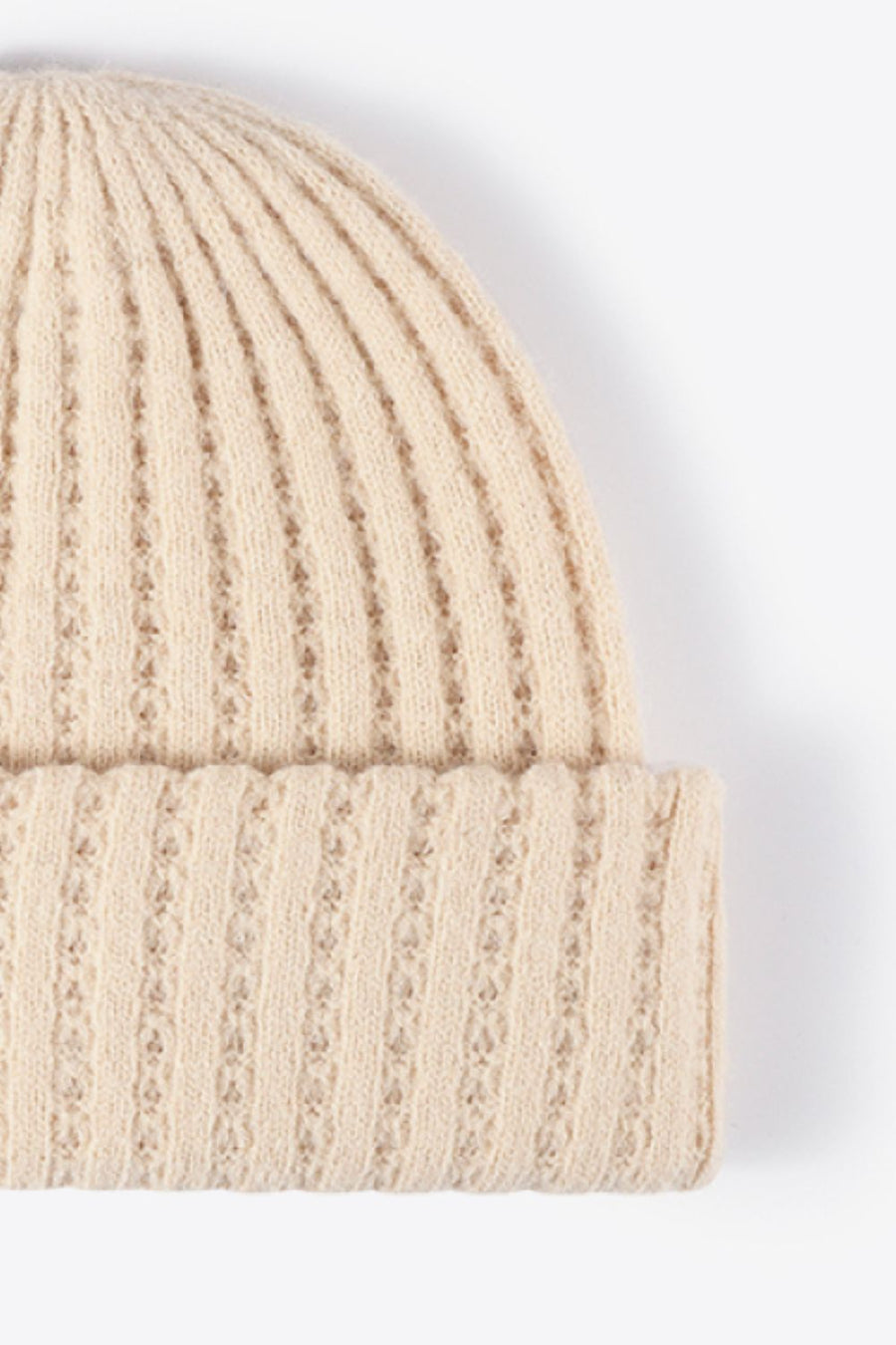 Beige ribbed knit beanie with subtle diamond pattern detail