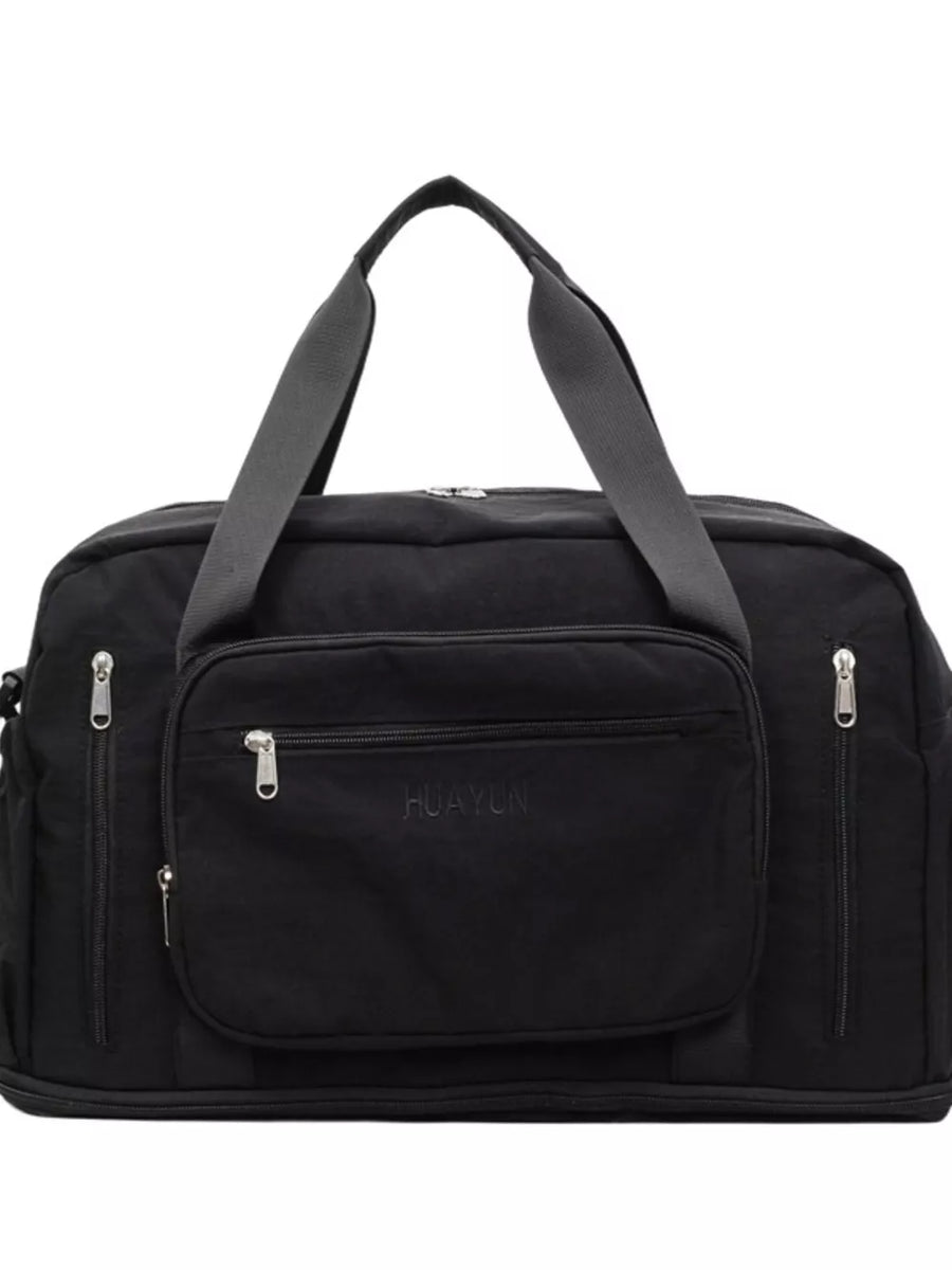 Black canvas duffel bag with multiple zippered pockets and grey straps.
