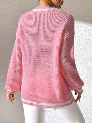 Dusty pink ribbed knit sweater with white varsity trim on neckline and cuffs.