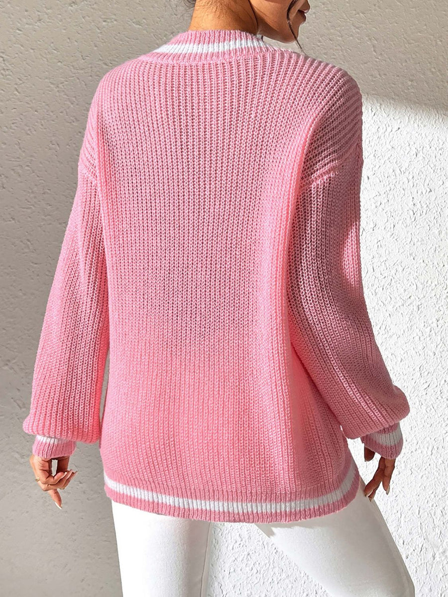 Dusty pink ribbed knit sweater with white varsity trim on neckline and cuffs.