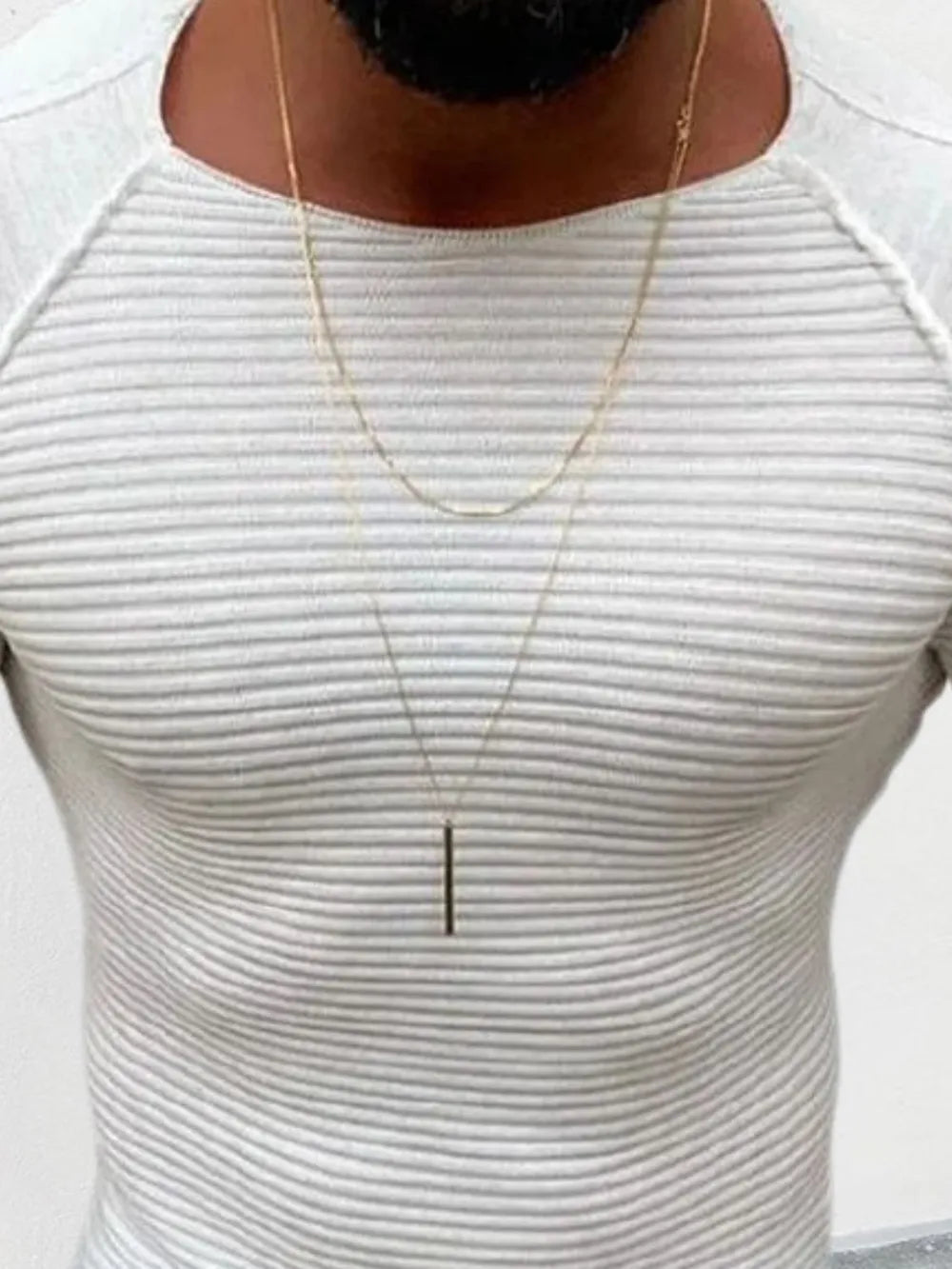Ribbed raglan tee in ivory with a sculptural fit, featuring a crew neck and short sleeves.