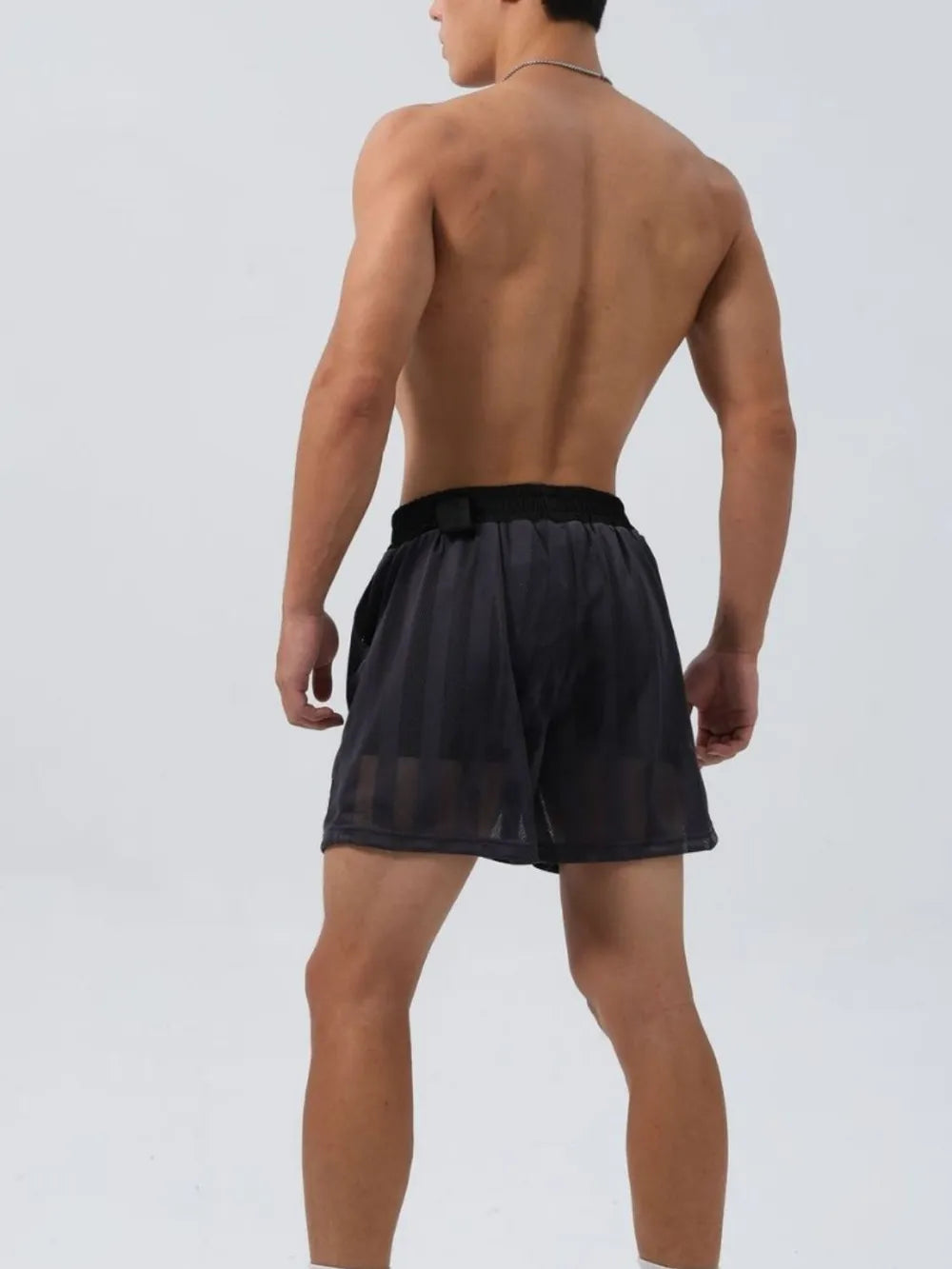 Performance mesh training shorts in dark gray with vertical stripe pattern.
