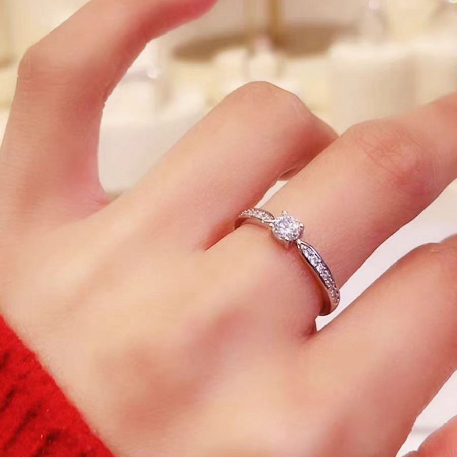 Sterling silver ring with moissanite solitaire and pave band.