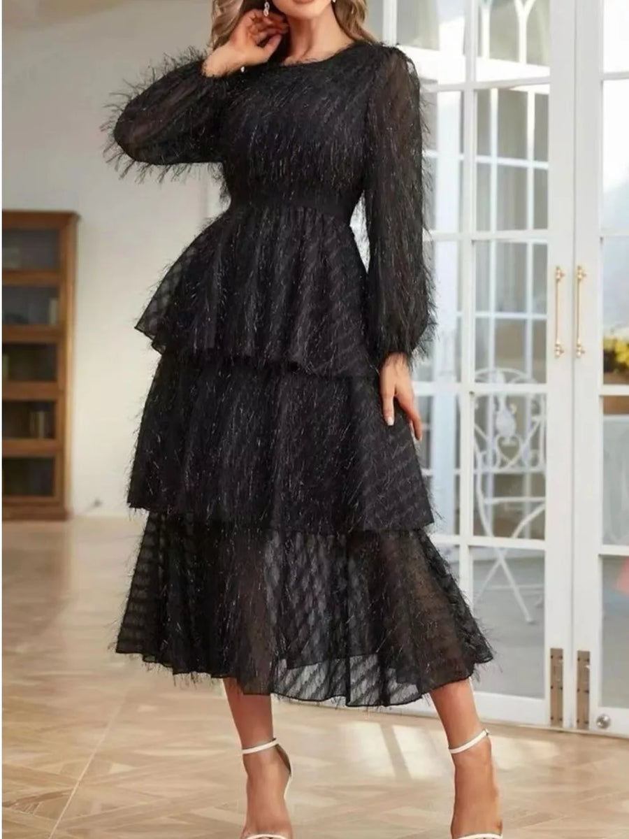 Black tiered midi dress with balloon sleeves and textured fabric.