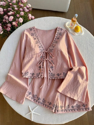 Pink embroidered tie-front top and shorts set with bell sleeves.