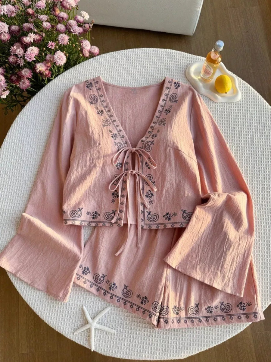 Pink embroidered tie-front top and shorts set with bell sleeves.