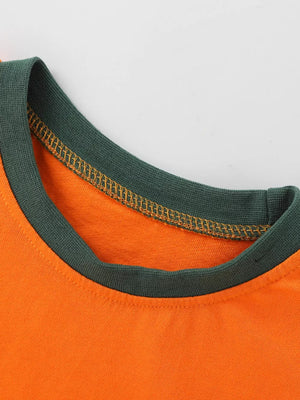 Orange t-shirt with dark green crew neck and contrast stitching