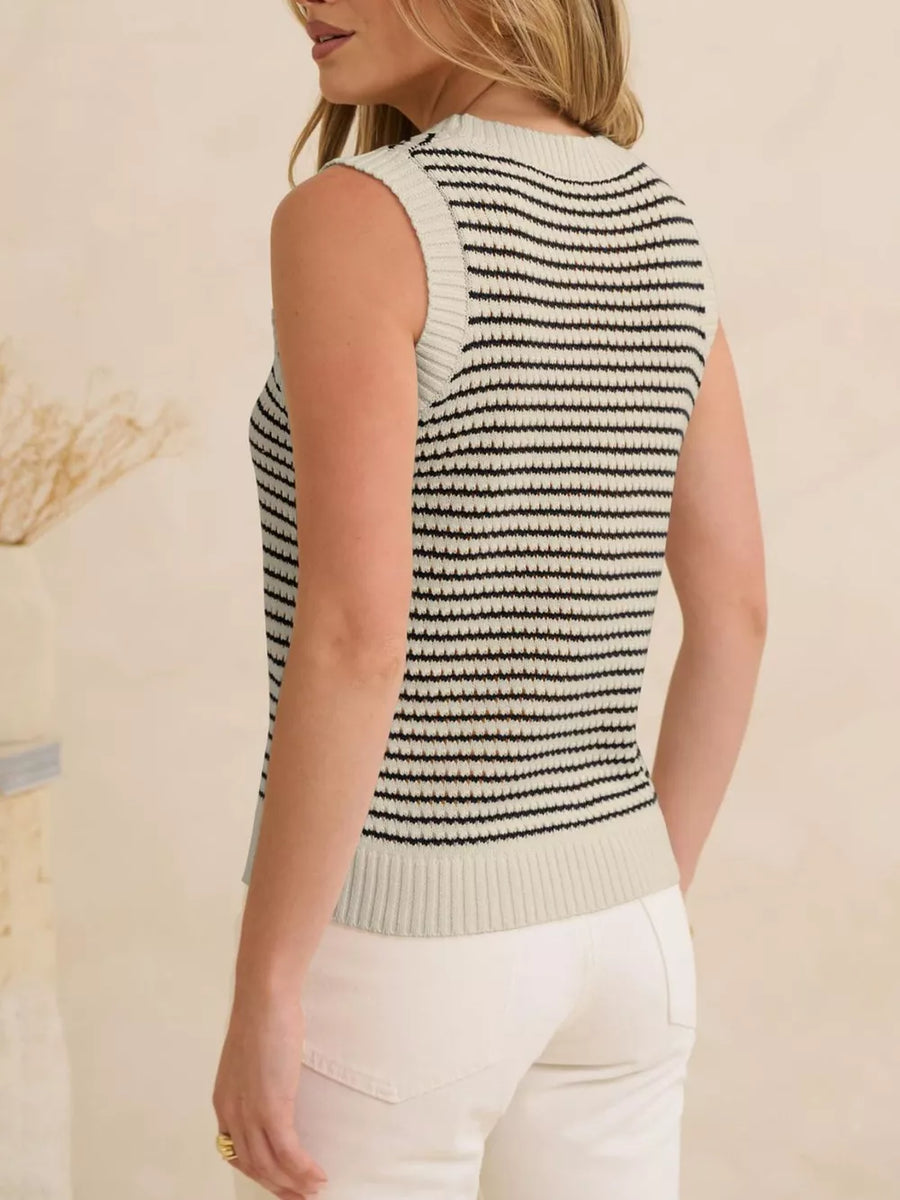 Textured striped knit sweater vest in white with black stripes, crew neck, sleeveless.
