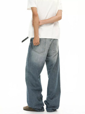 Relaxed-fit men's jeans in blue plaid pattern with buttoned closure.