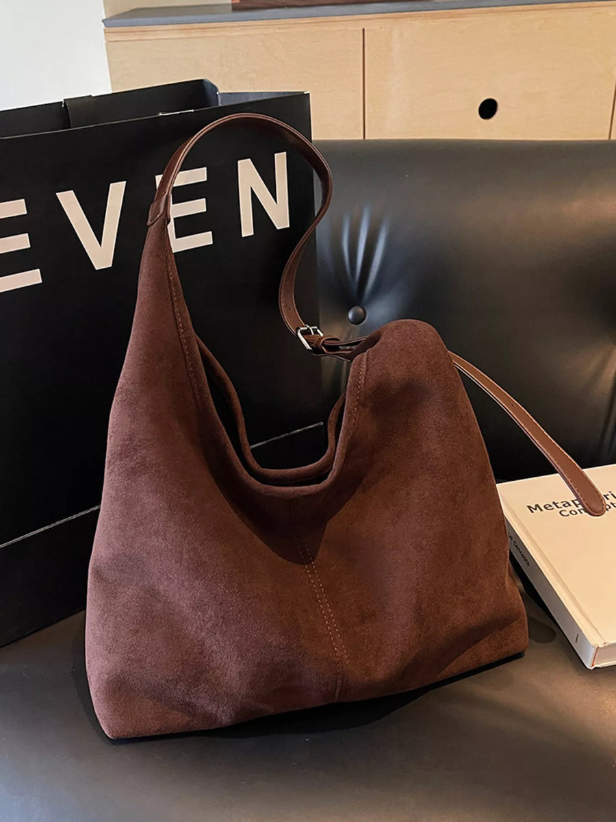 Brown suede hobo bag with adjustable strap and visible stitching detail.