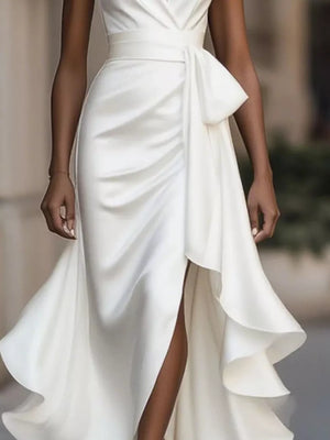 White halter maxi dress with ruffled asymmetrical skirt and belted waist.