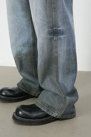 Faded gradient wide-leg jeans in medium wash denim with distressed detail