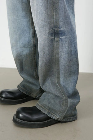 Faded gradient wide-leg jeans in medium wash denim with distressed detail