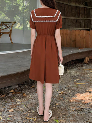 Brown short sleeve dress with lace-trimmed sailor collar and cinched waist