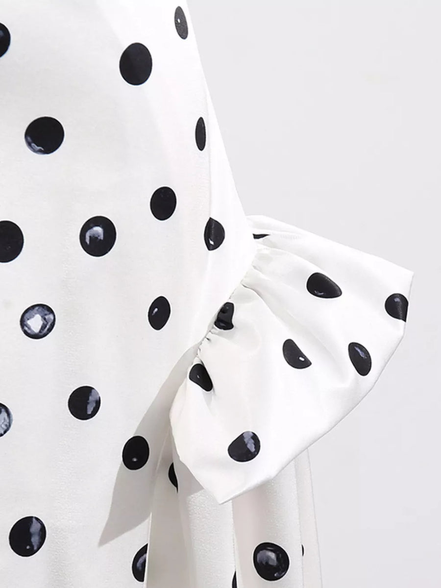 White polka dot dress with ruffled sleeve detail.