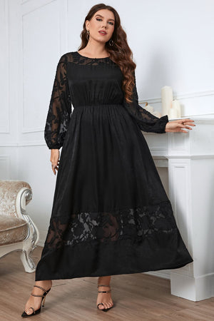 Black maxi dress with sheer embroidered sleeves and hem, round neck, and A-line cut.