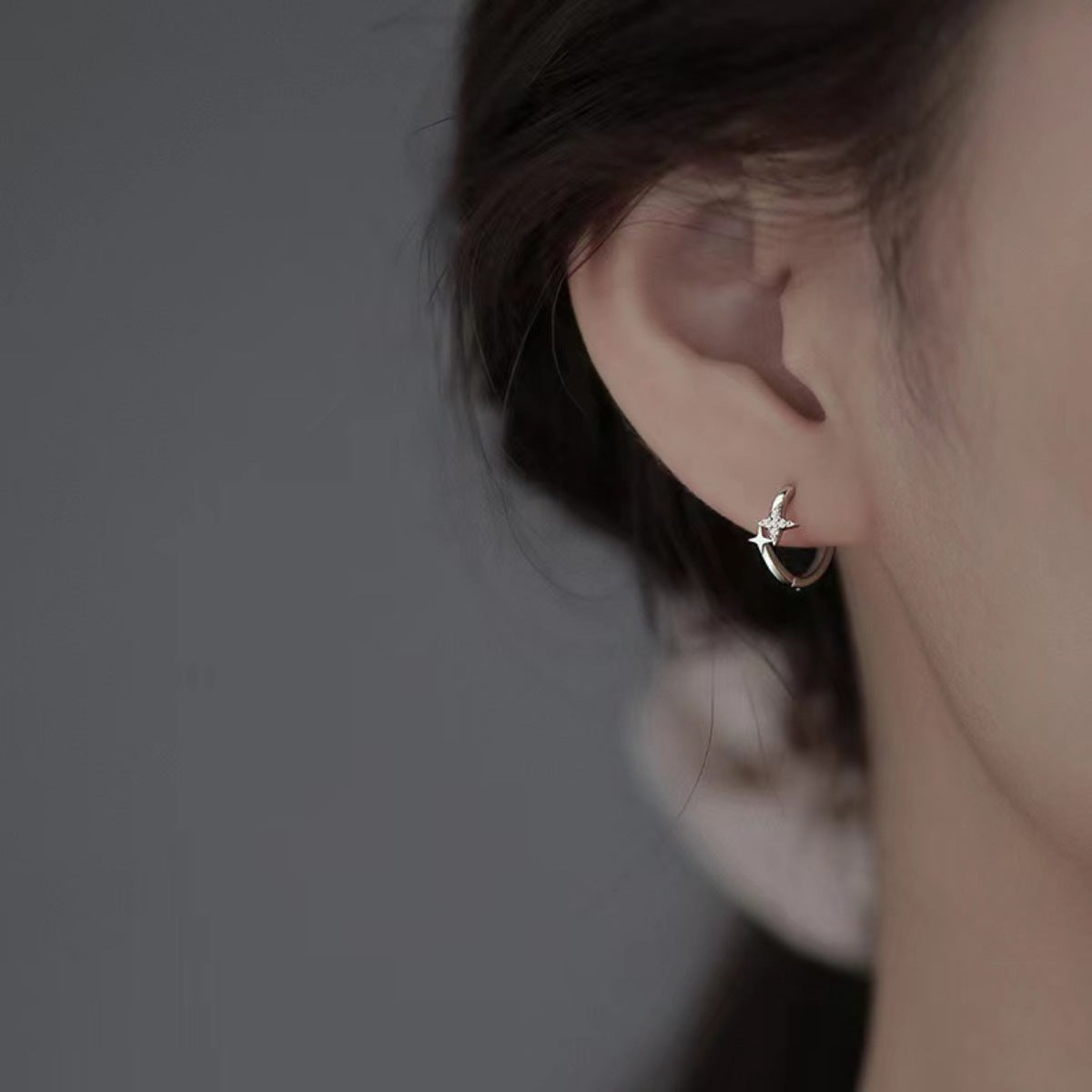earrings in silver featuring star motif and hoop fit