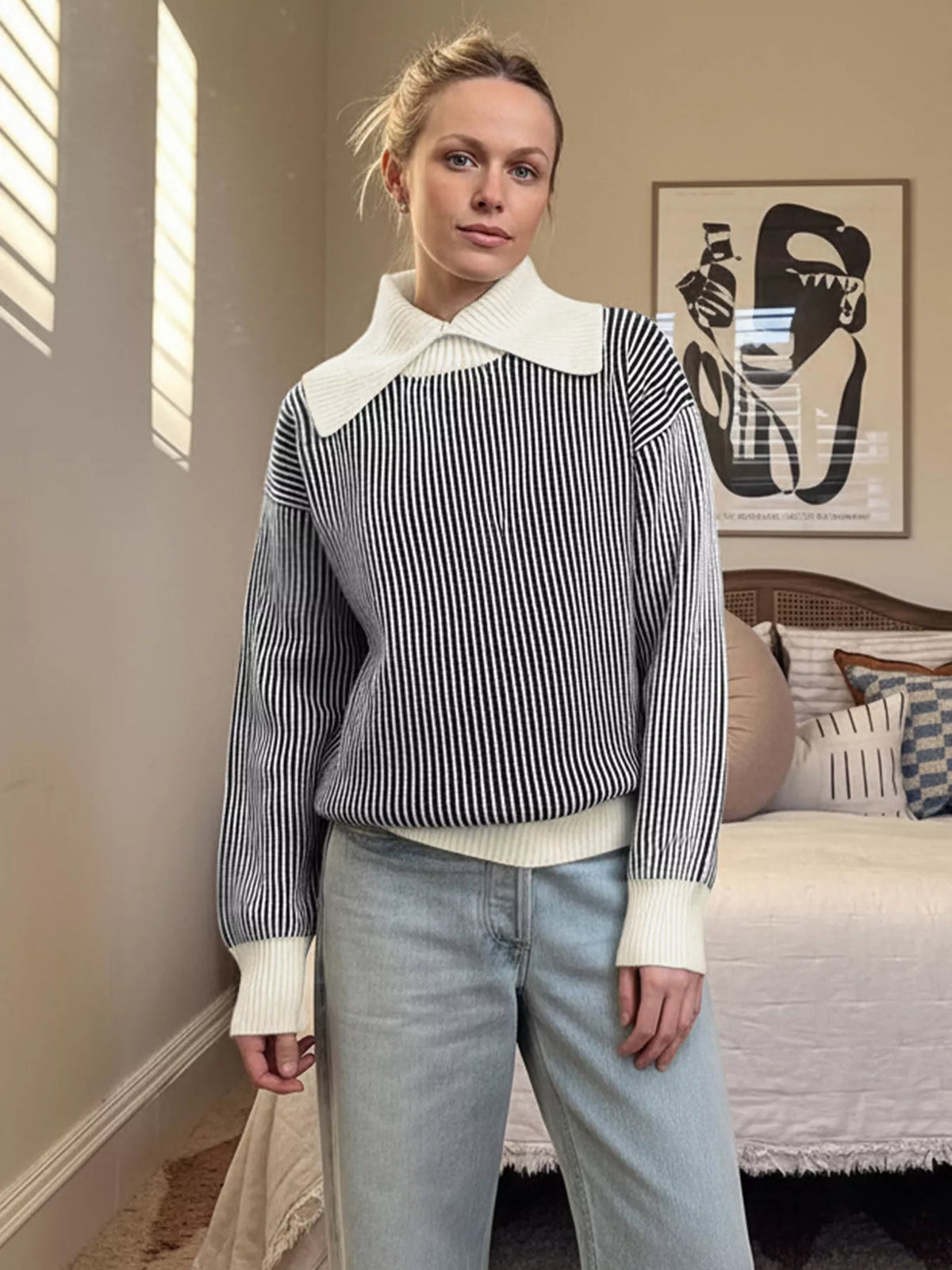 Striped knit sweater in black with a contrast white collar and cuffs.