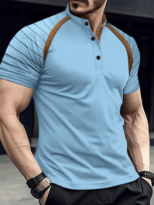 Light blue polo shirt with brown contrast raglan sleeves and mandarin collar.