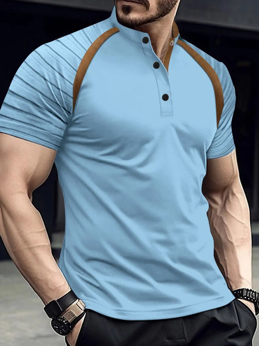 Light blue polo shirt with brown contrast raglan sleeves and mandarin collar.