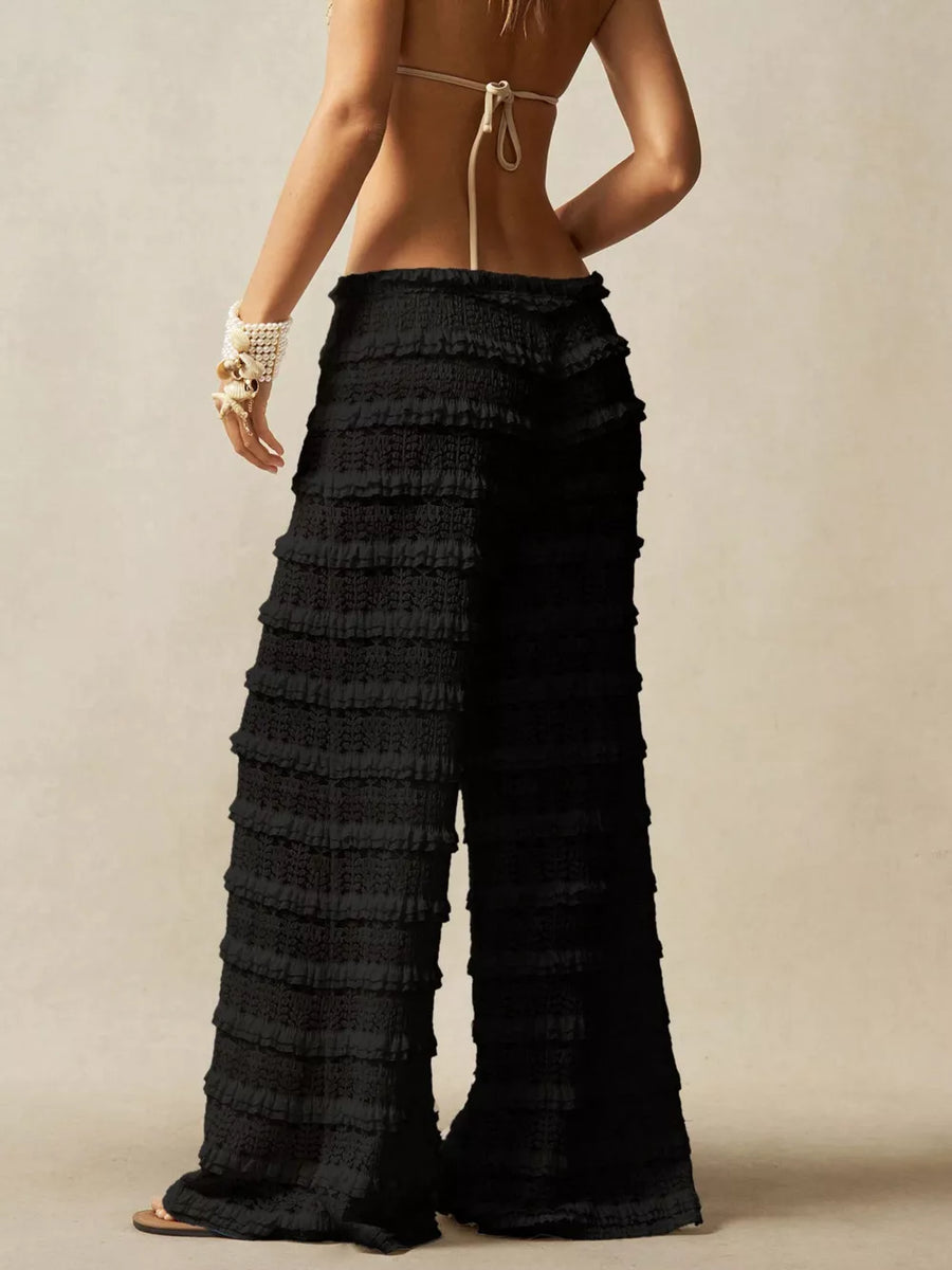 Black crochet wide-leg pants with tiered ruffle detailing and a high waist.