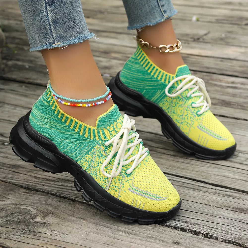 Vibrant two-tone yellow and green lace-up sneakers with chunky black soles and ankle beads.