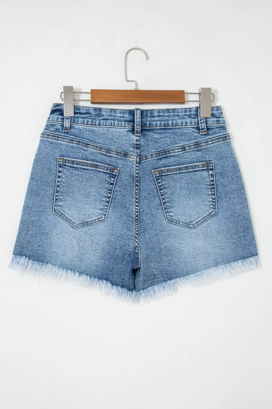 Blue denim shorts with distressed details and frayed hem