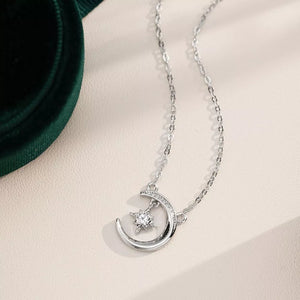 Celestial moissanite crescent necklace with a star charm, silver tone.