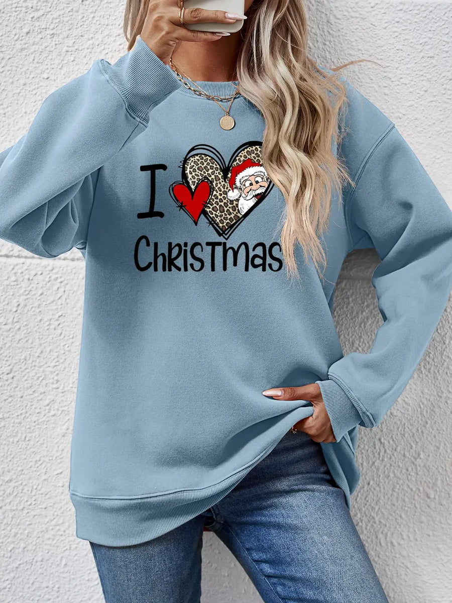 Light blue crewneck sweatshirt with festive heart graphic and Santa detail.