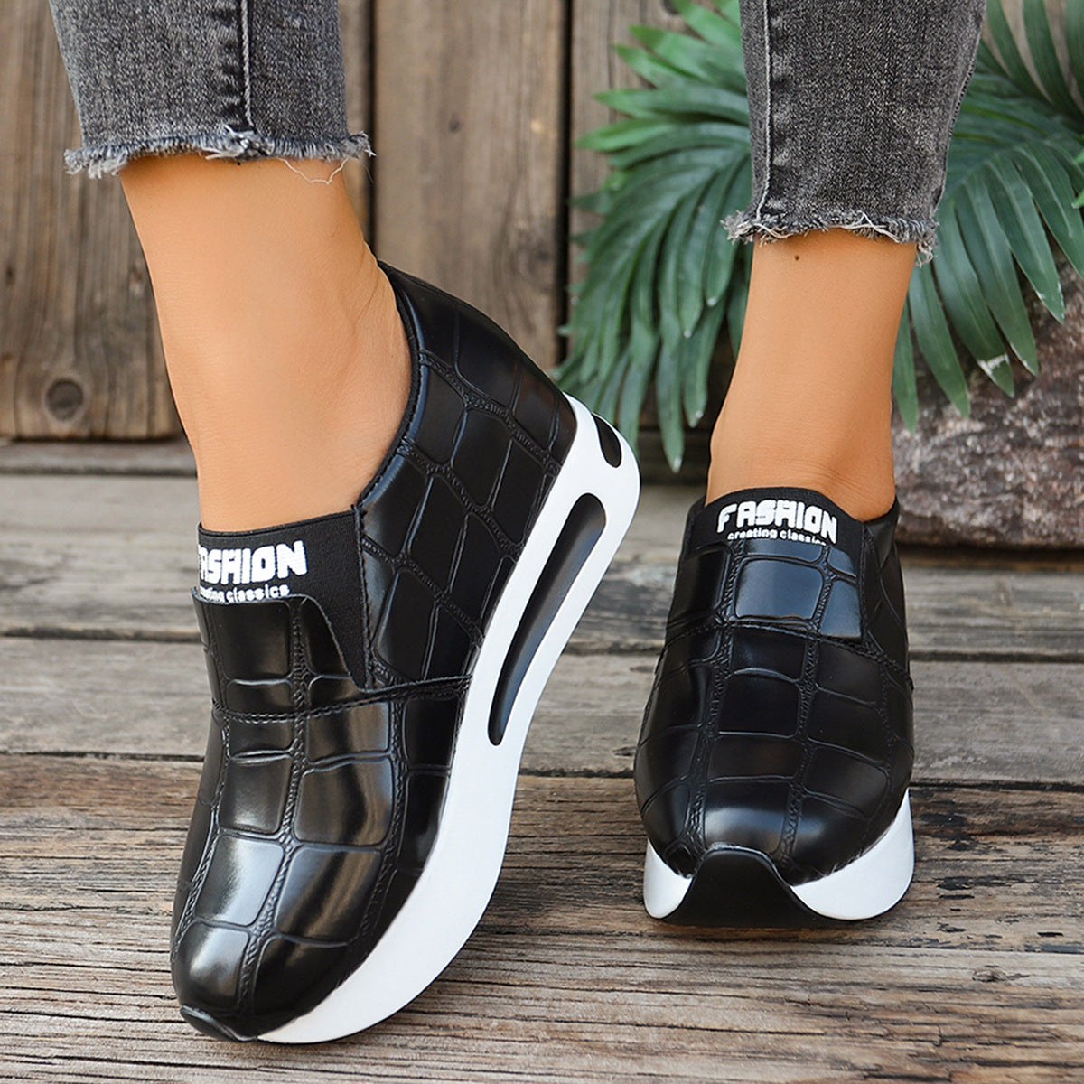 Black crocodile pattern slip-on flats with chunky white sole and "Fashion" detail.