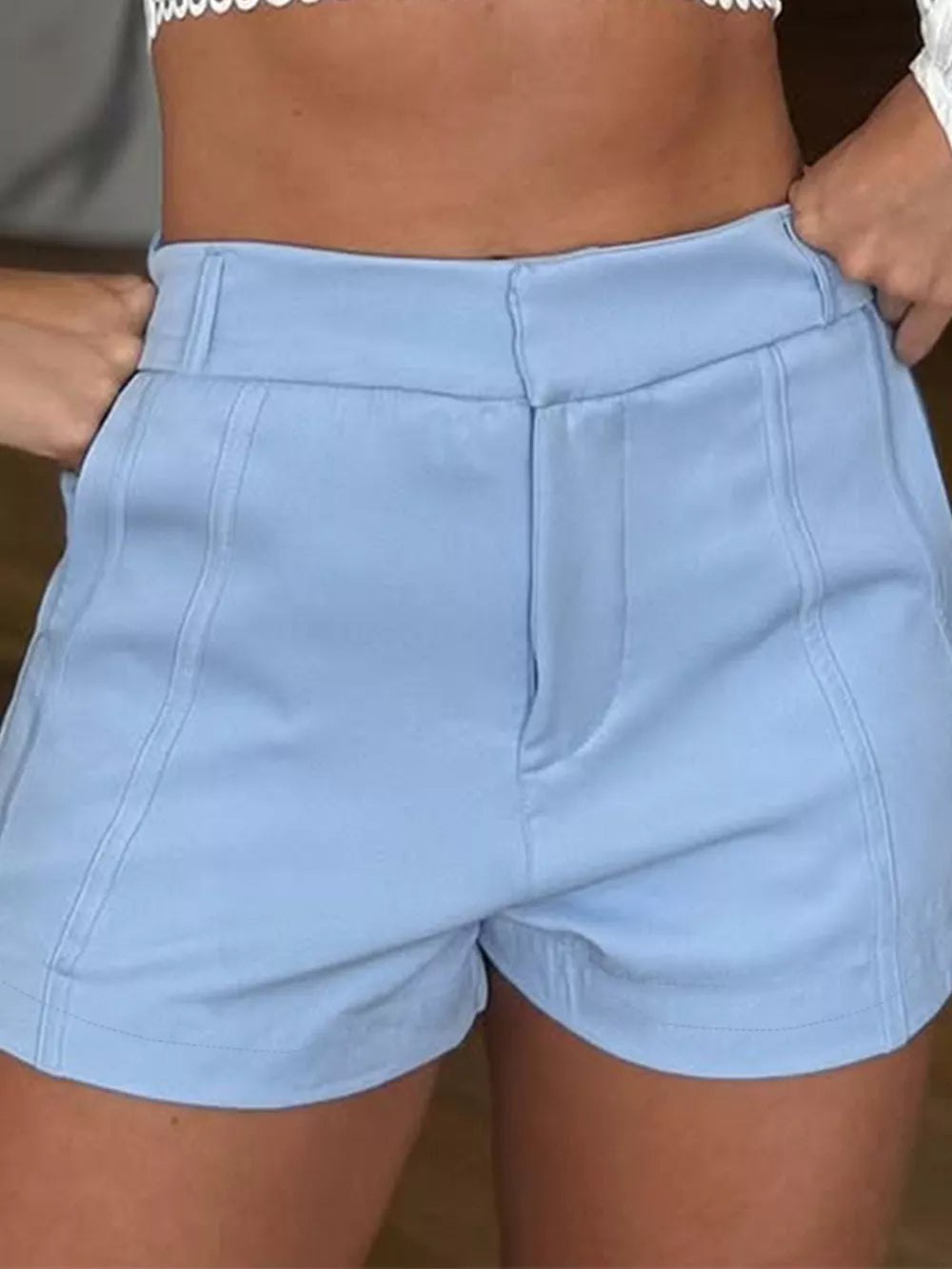 Light blue cuffed high-waisted shorts with seam detail and a relaxed fit.