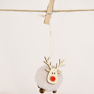 Whimsical pom-pom reindeer ornament with wooden antlers and red nose, hanging on twine.