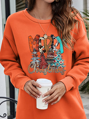 Orange crewneck sweatshirt with extended hemline and festive "Merry Christmas" graphic featuring trees.
