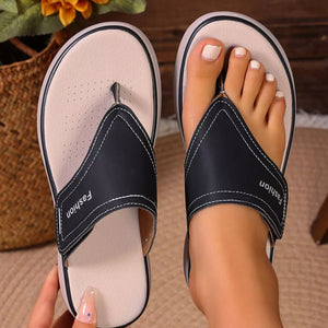 Chic toe post platform sandals in black with white stitching and "Fashion" detail.