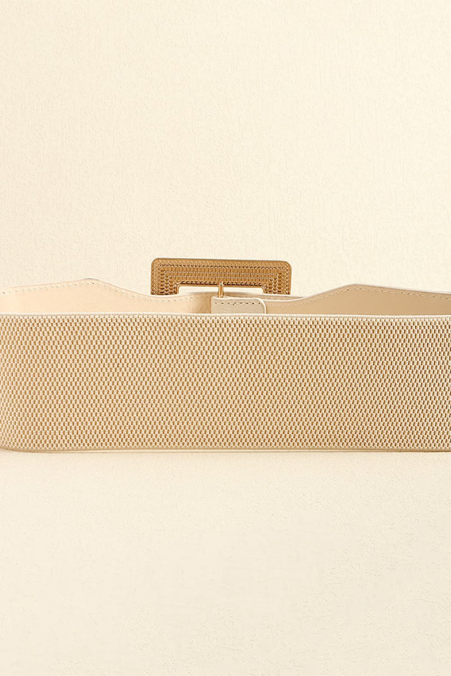 Textured buckle elasticated waist belt in ivory with gold-tone hardware.