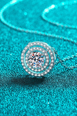 Silver halo diamond pendant necklace with a central clear gemstone and a delicate chain.