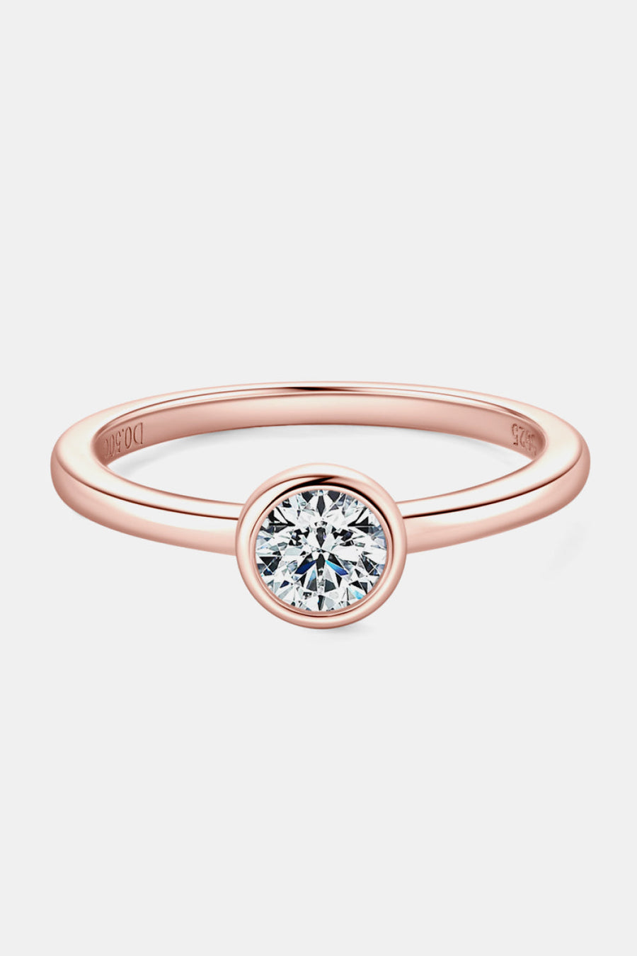Rose gold solitaire bezel ring with a round-cut diamond.