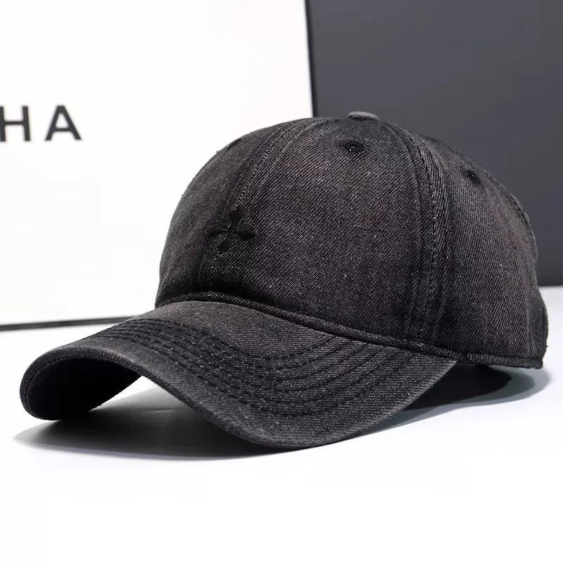 Black denim baseball hat with embroidered detail and curved brim