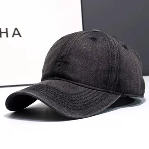 Black denim baseball hat with embroidered detail and curved brim