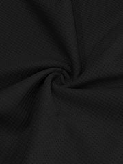 Black cotton t-shirt fabric with a waffle knit texture.