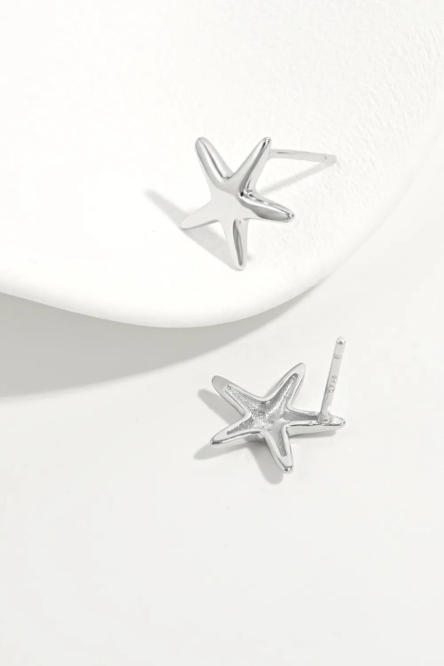 Sculpted starfish stud earrings in silver, featuring a detailed starfish design.