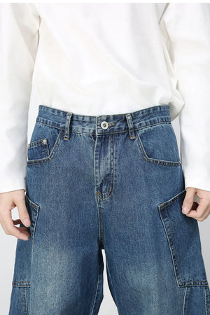 Medium wash denim balloon trousers with cargo pockets and a relaxed fit.