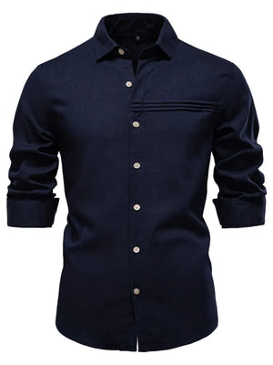 Navy linen button-up shirt with pleated pocket detail and cuffed sleeves.