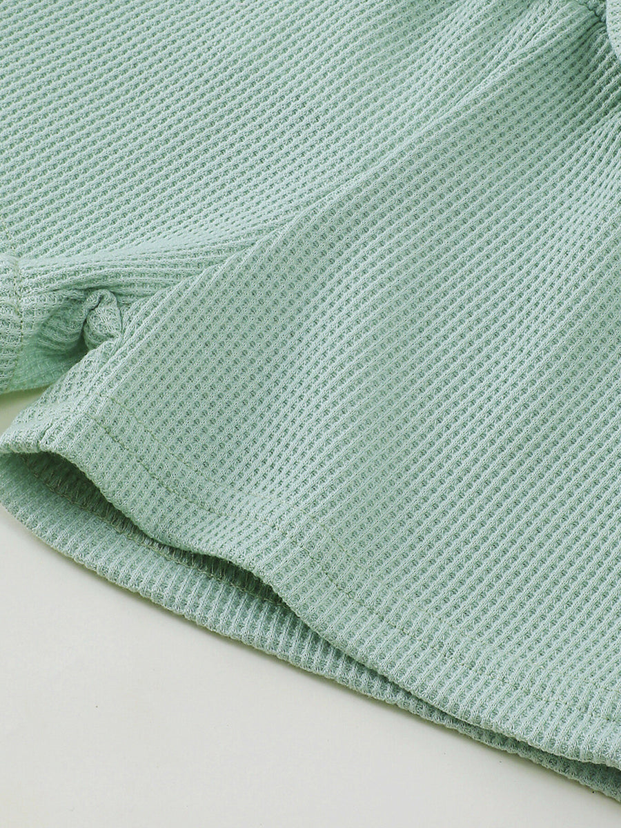 Green waffle knit tank and bow shorts set detail, cotton blend fabric.