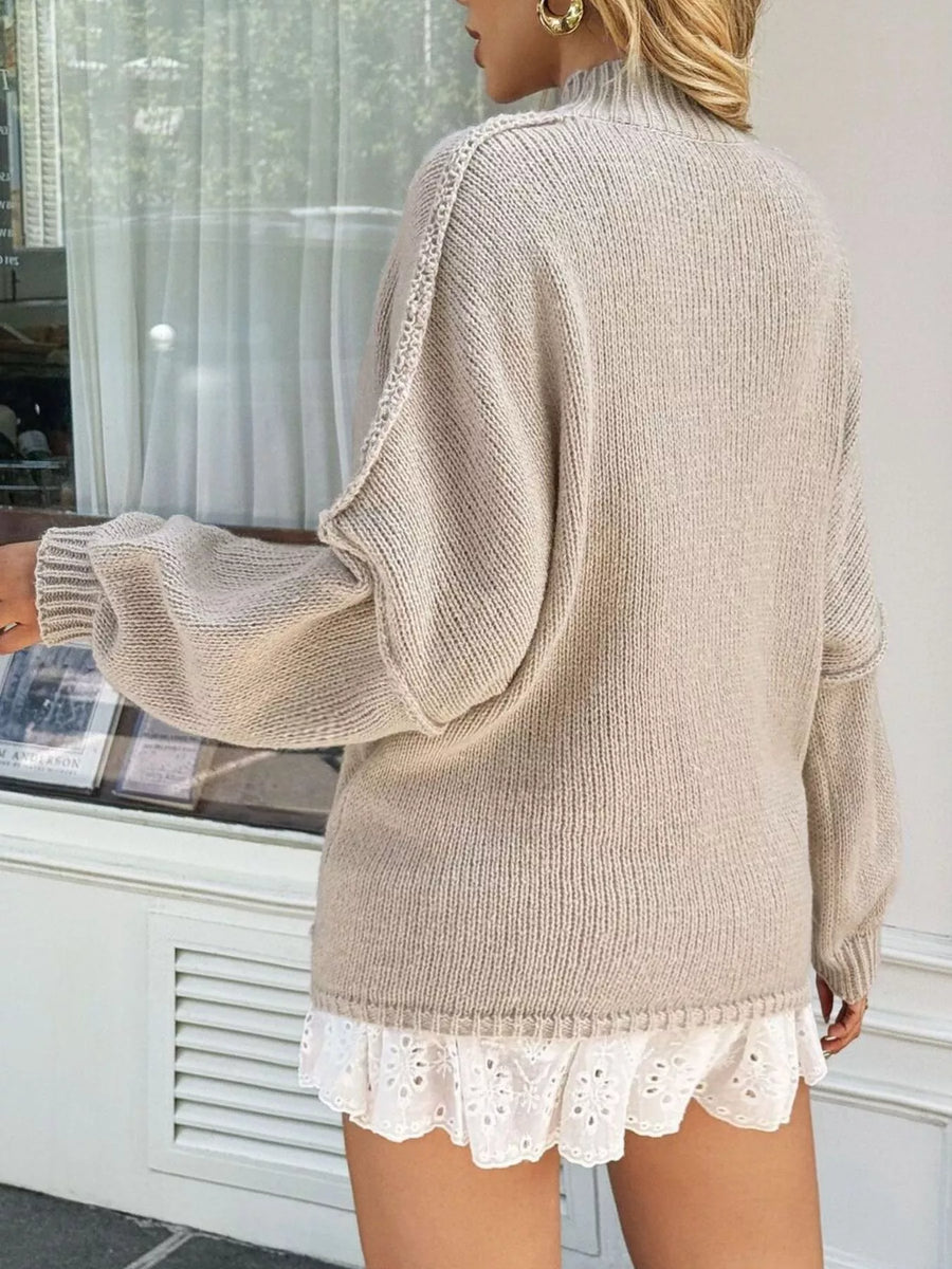 Mock neck oversized sweater in khaki with drop shoulders and textured sleeves.